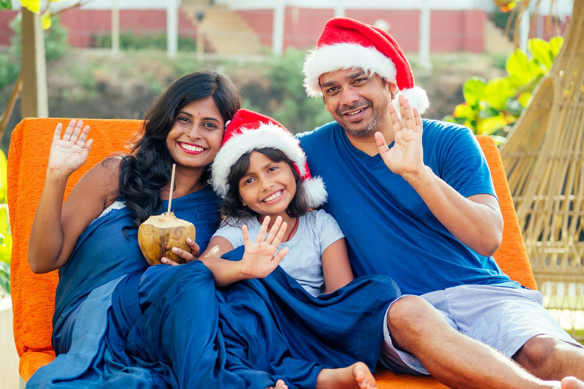Happy Indian couple and daughter celebrating new year in tropical resort